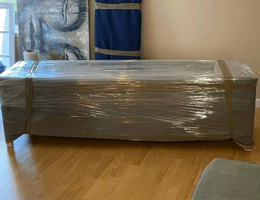 Sofa wrapped inside a customer's home before moving